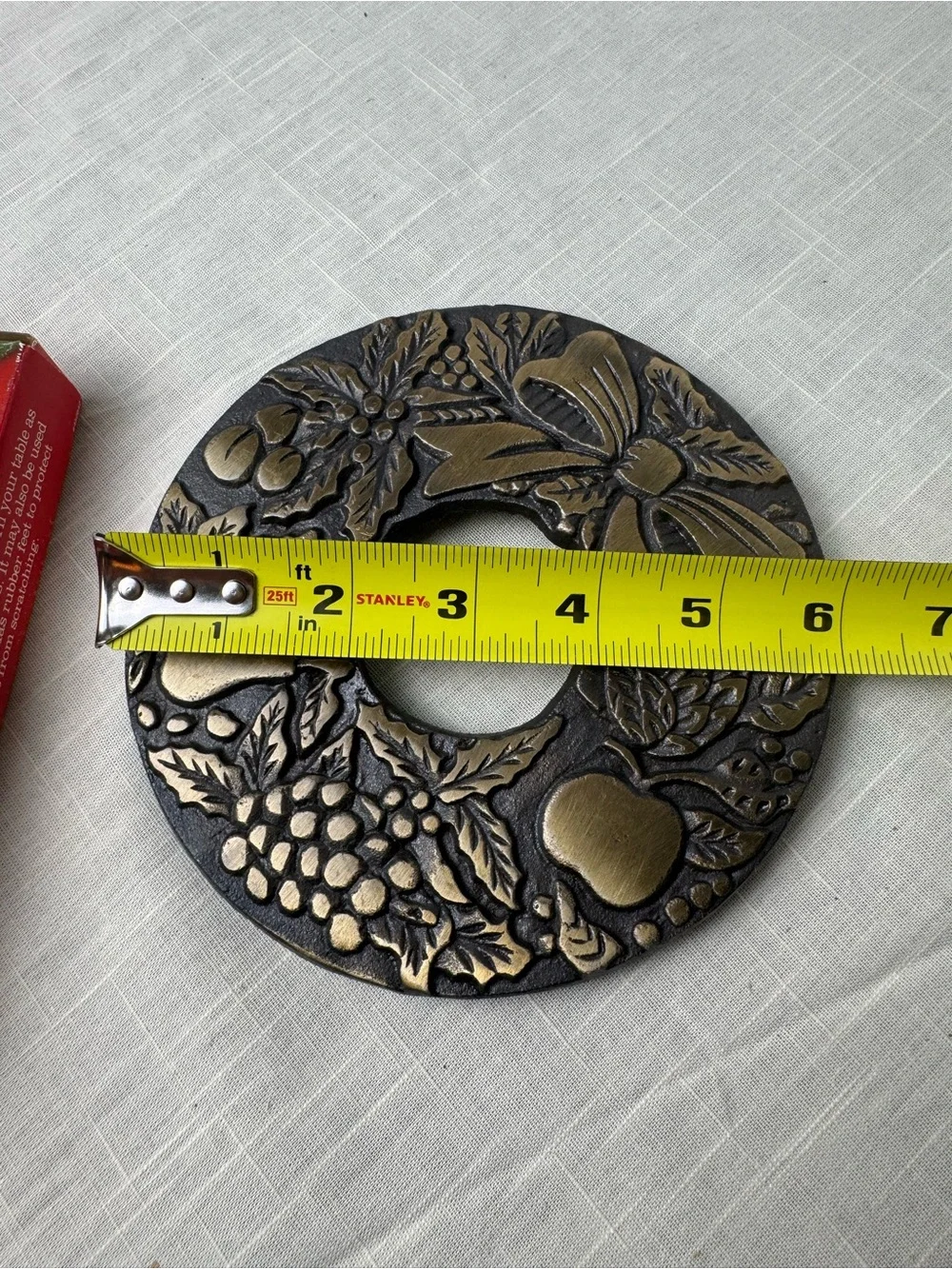 Della Robbia VTG Wreath Trivet 6 in round with bow and fruit design Heavy metal